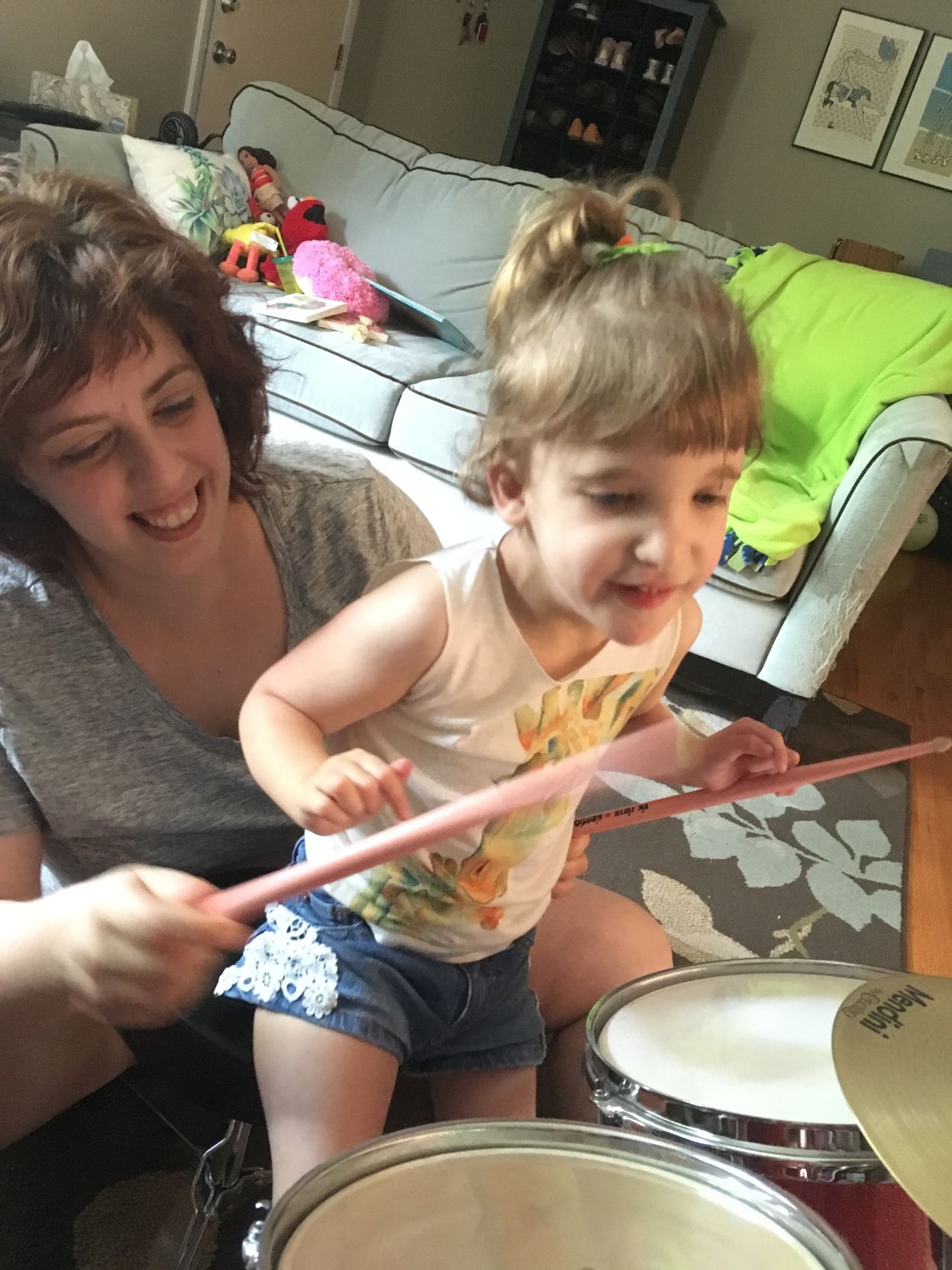 Christina Ingoglia helps her daughter, Lily, play drum